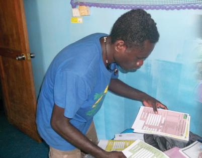 Man examining survey papers Solomon Islands
