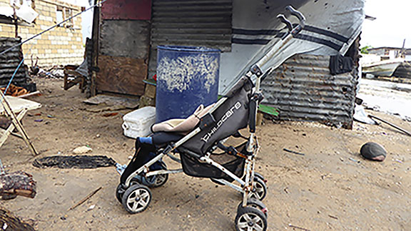 Pram by shack, Tonga poverty