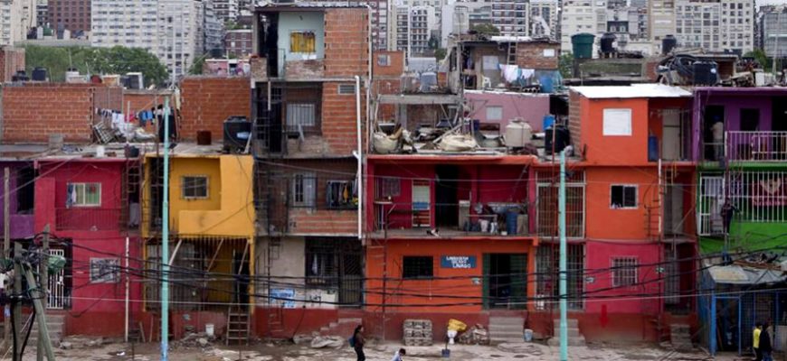 Poor housing in Buenos Aires with high rises in background 2017