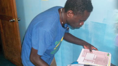 Man examining survey papers Solomon Islands