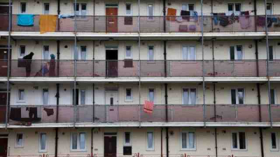 Landings of flats with balconies, 1960s style, in run-down estate.